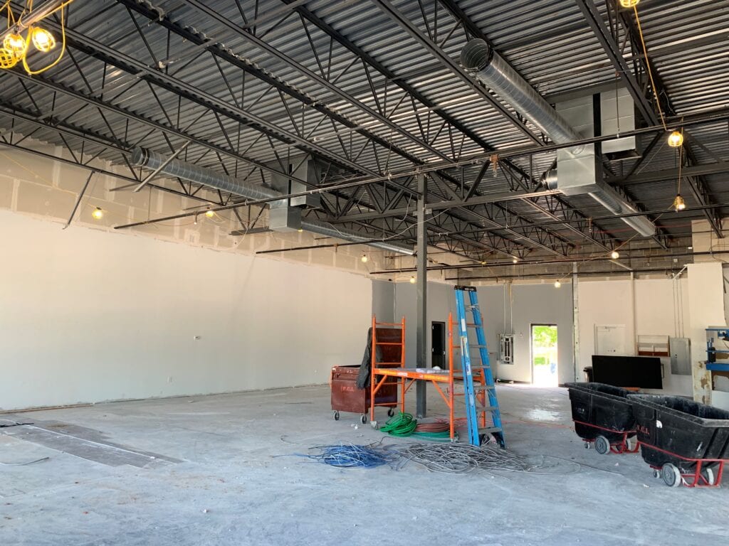 A room with a ladder and some construction equipment.