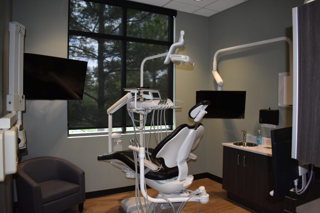 A dentist 's office with an open window and chair.